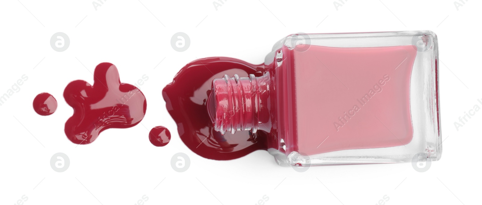 Photo of Bottle and spilled red nail polish isolated on white, top view