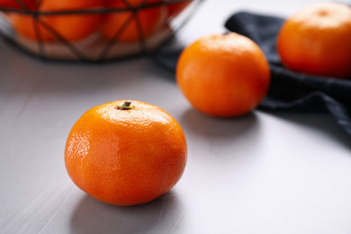 Photo of Fresh ripe tangerine on light grey table