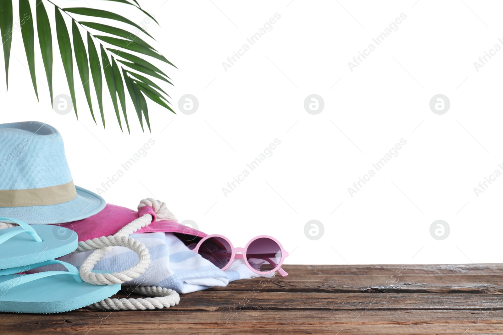 Photo of Different beach objects on wooden table against white background. Space for text