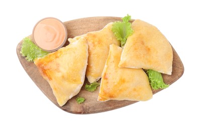 Photo of Wooden board with delicious samosas, lettuce and sauce isolated on white, top view