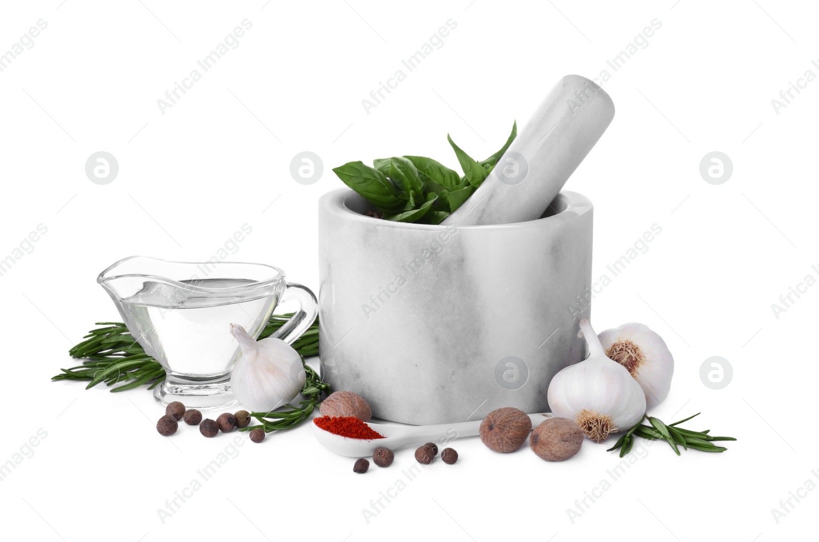 Photo of Mortar with pestle and different spices on white background