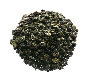 Photo of Pile of dried green tea leaves on white background, top view