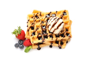 Photo of Delicious waffles with berries, ice cream and chocolate syrup on white background, top view