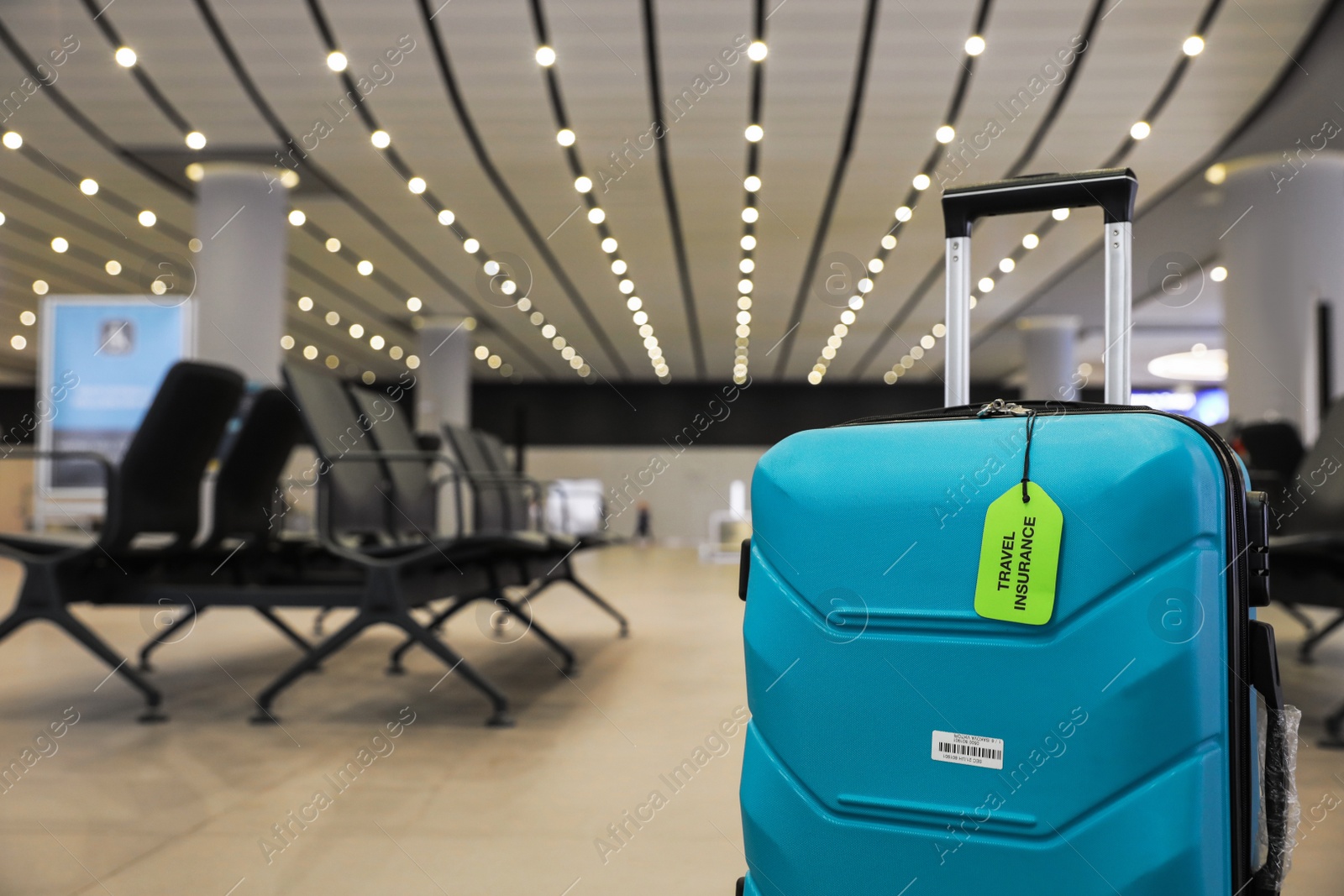 Photo of Suitcase with TRAVEL INSURANCE label indoors. Space for text