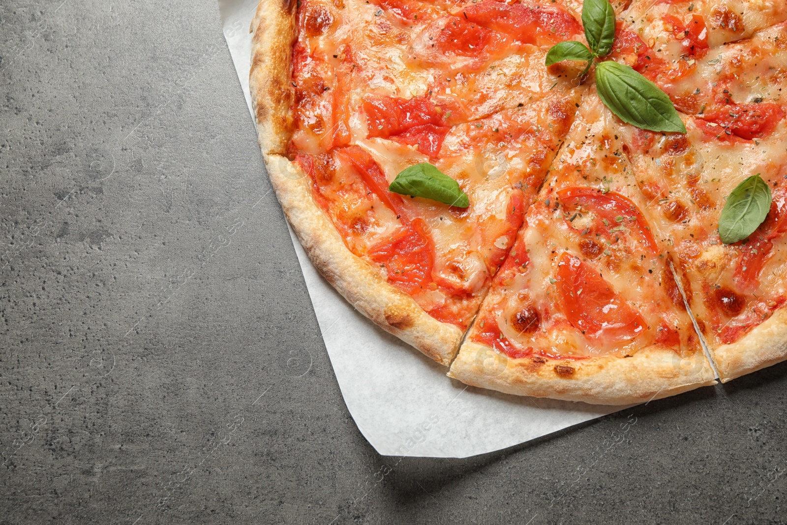 Photo of Delicious pizza Margherita on grey table, top view