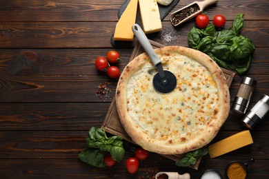 Flat lay composition with delicious cheese pizza and ingredients on wooden table. Space for text