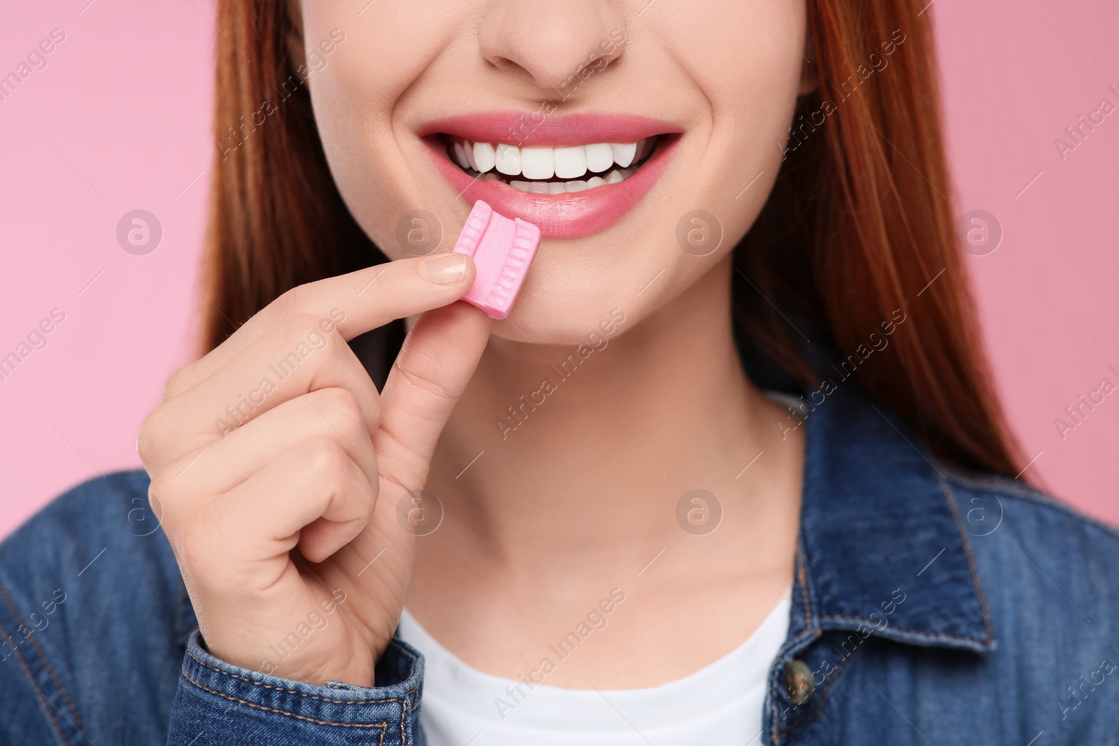 Photo of Woman with bubble gum on pink background, closeup