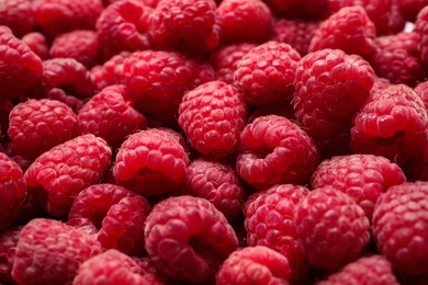 Photo of Delicious fresh ripe raspberries as background, closeup