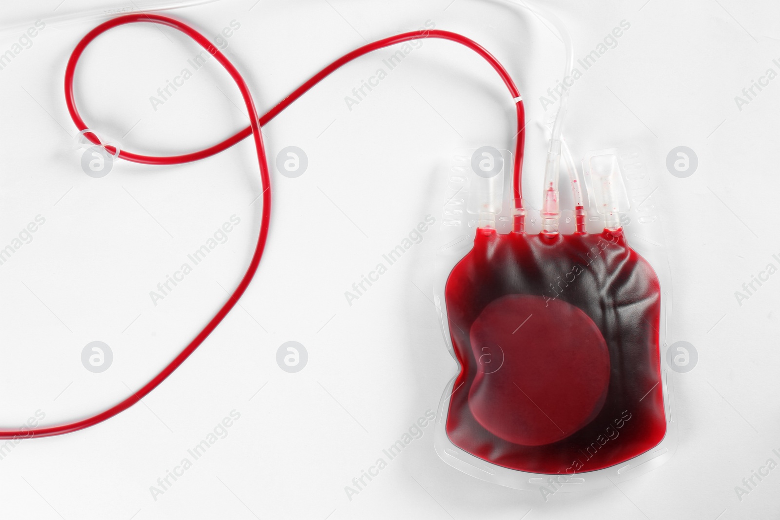 Photo of Blood pack for transfusion on white background, top view. Donation day