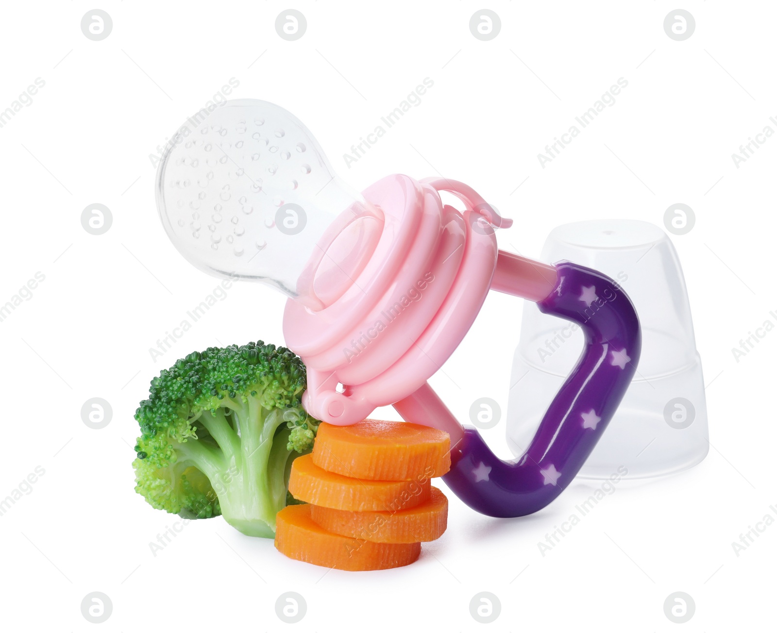 Photo of Empty nibbler with boiled broccoli and cut carrot on white background. Baby feeder