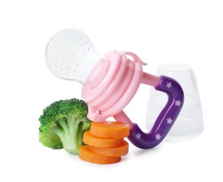 Photo of Empty nibbler with boiled broccoli and cut carrot on white background. Baby feeder