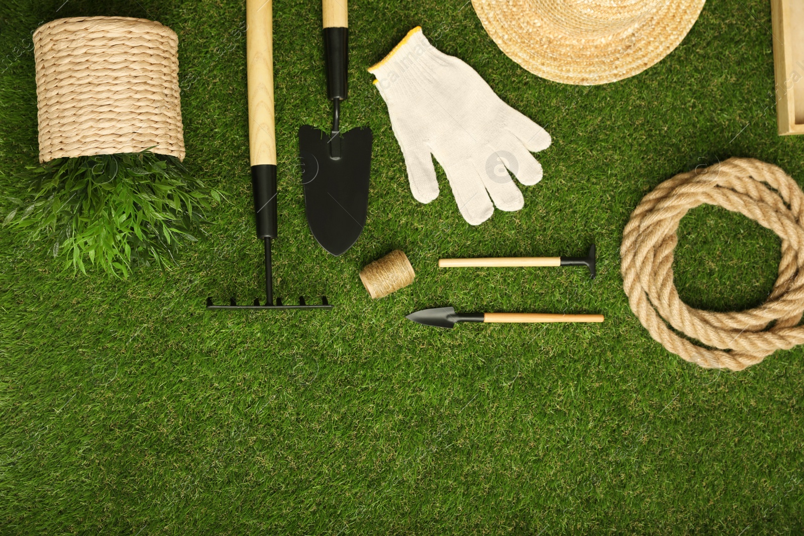 Photo of Set of gardening tools on green grass, flat lay. Space for text