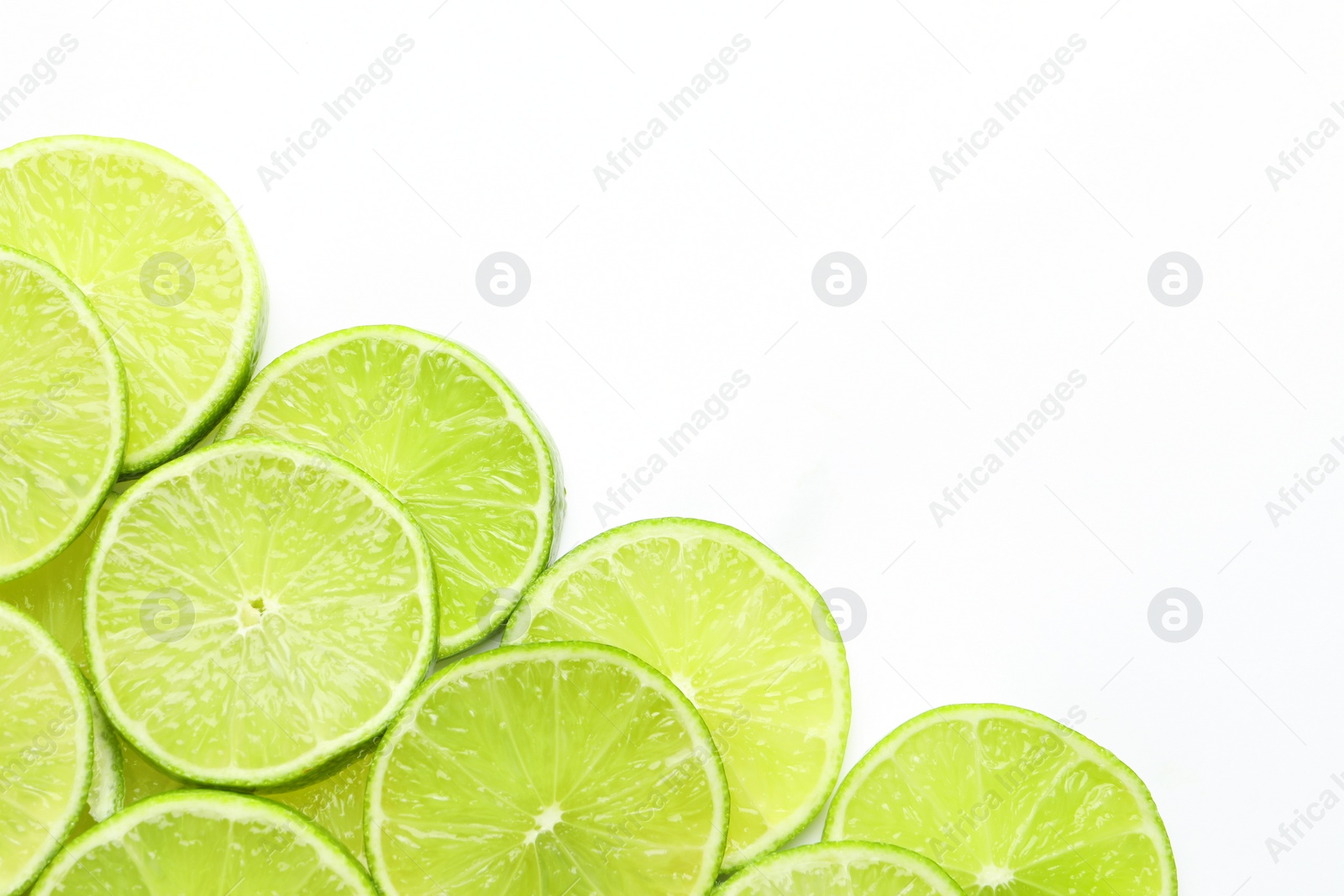 Photo of Fresh juicy lime slices on white background, flat lay. Space for text