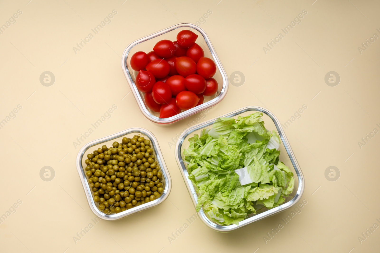 Photo of Glass containers with different fresh products on beige background, flat lay