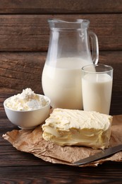 Photo of Tasty homemade butter and dairy products on wooden table
