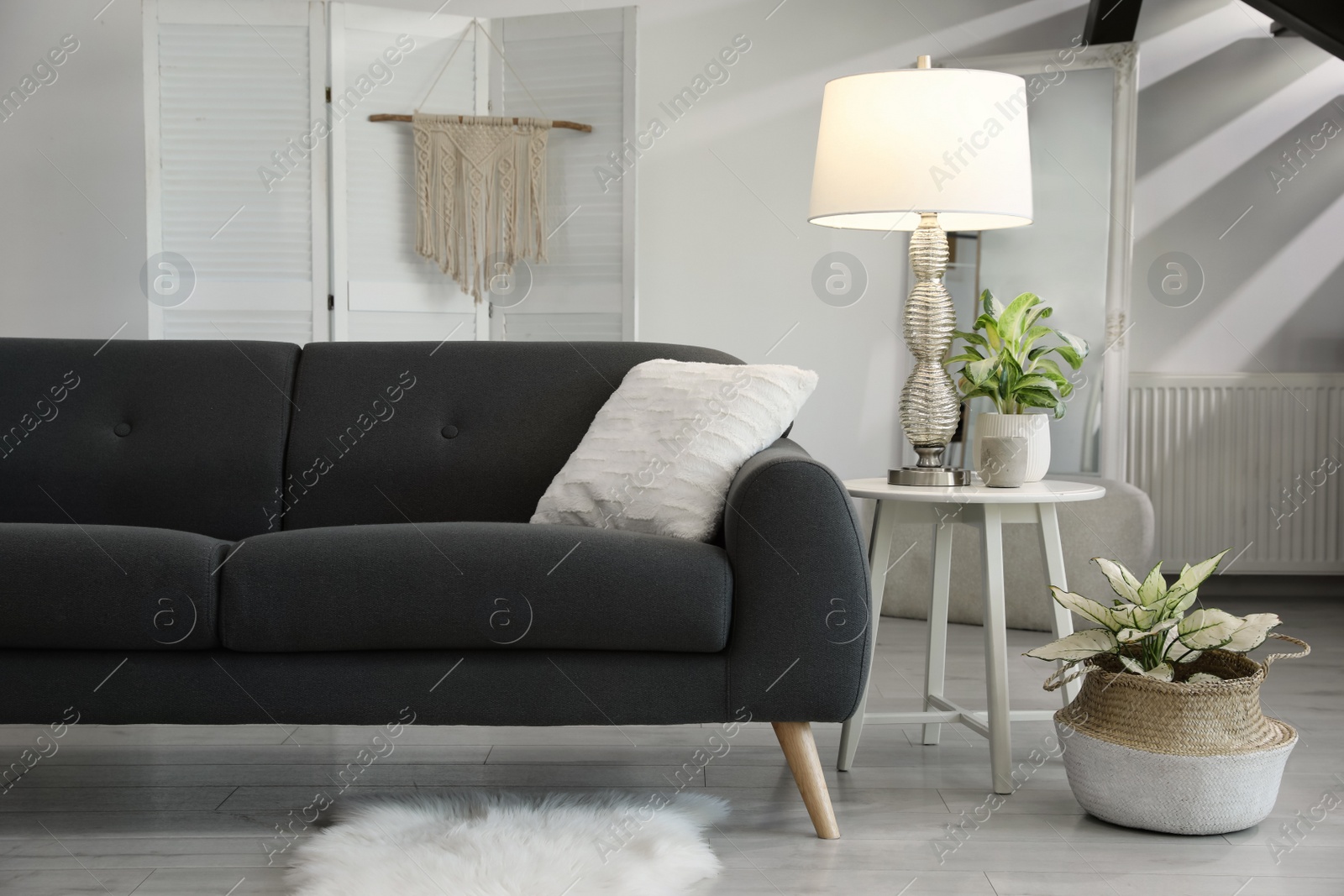 Photo of Living room interior with stylish lamp and comfortable sofa