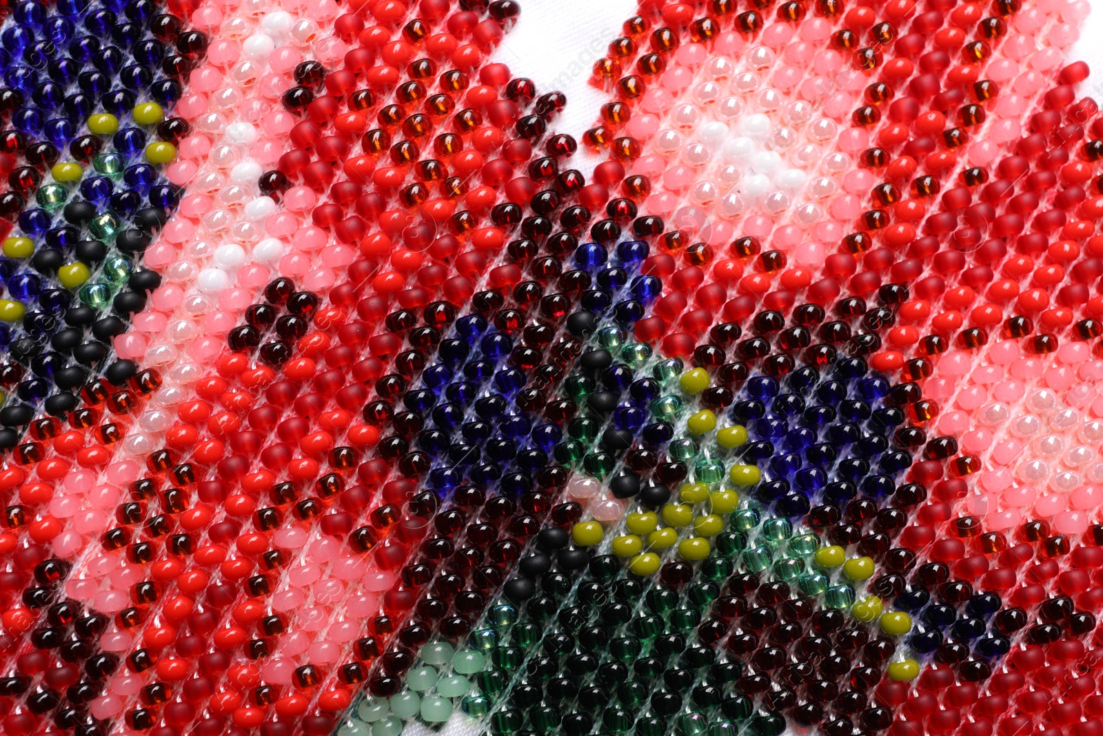 Photo of Beautiful floral bead embroidery as background, closeup