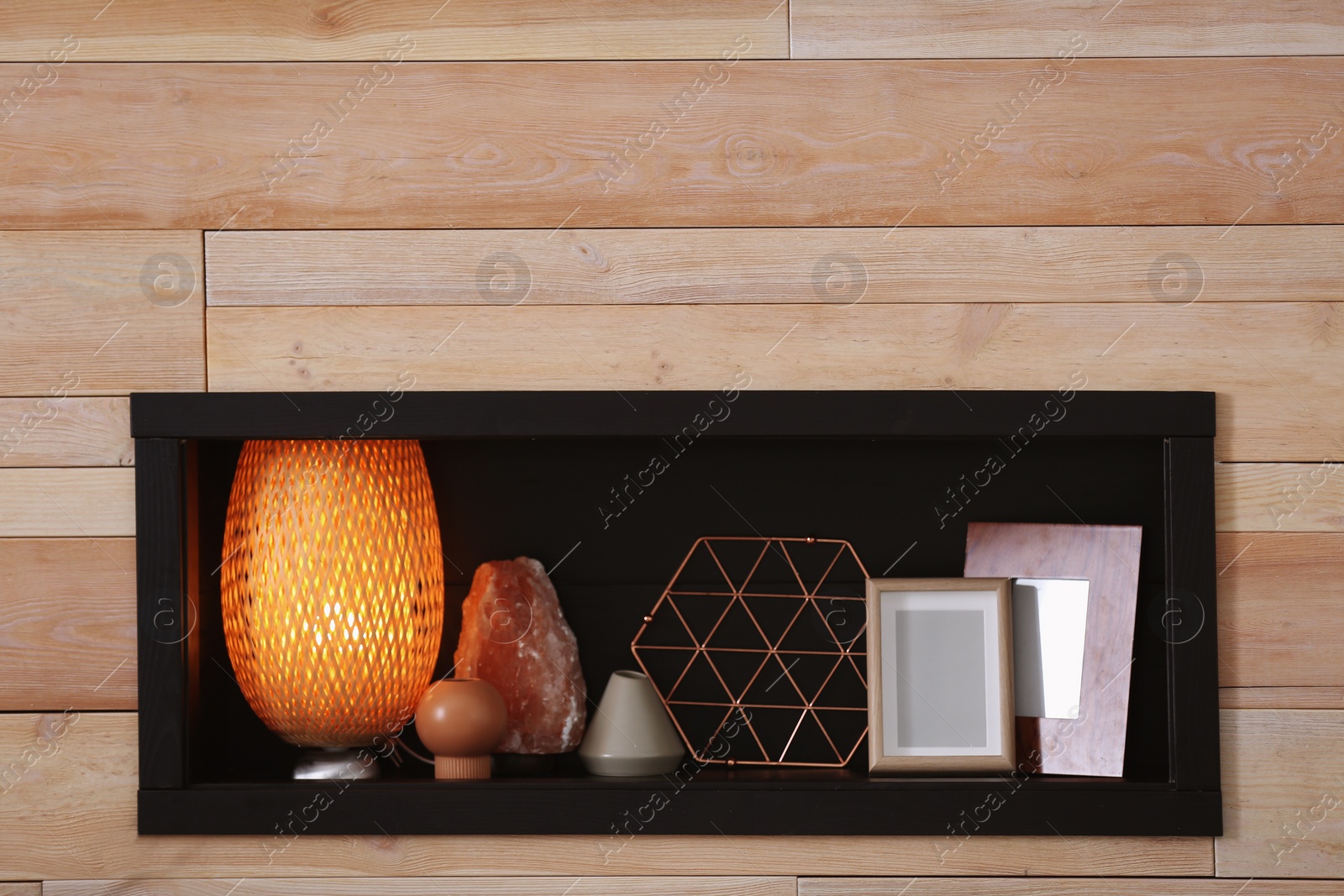 Photo of Niche with decorative elements in wooden wall. Interior design