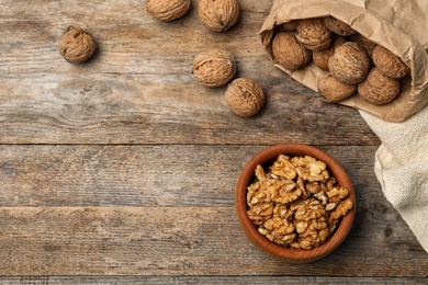 Flat lay composition with walnuts and space for text on wooden background