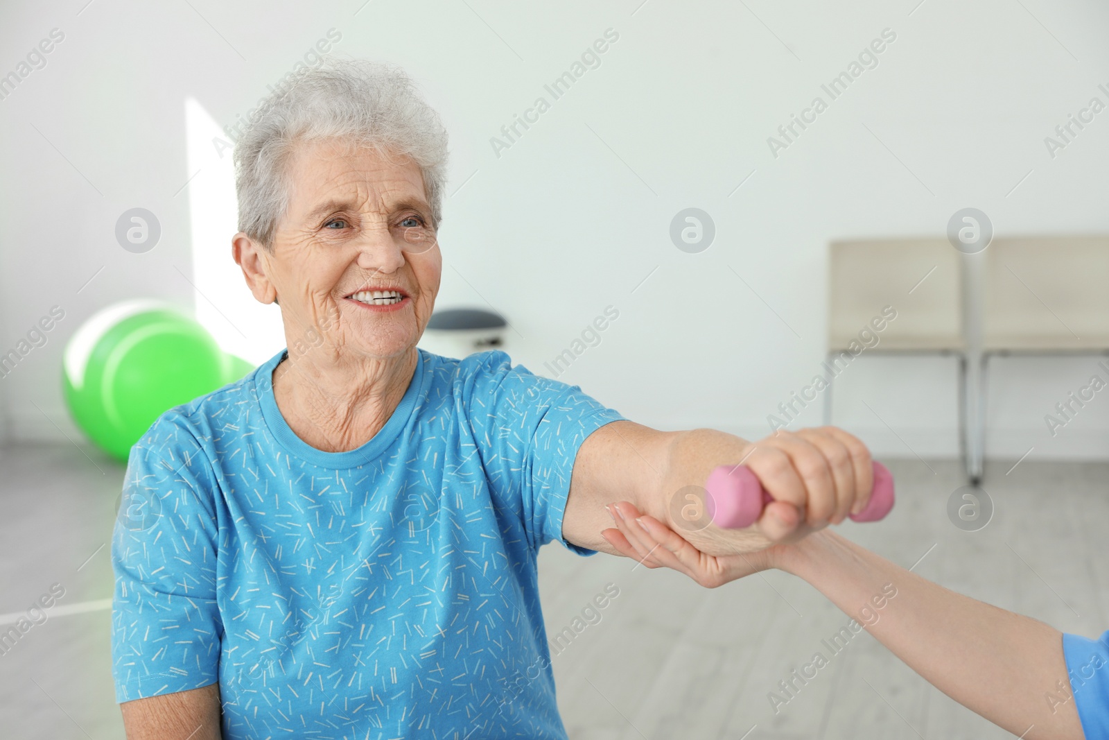 Photo of Professional physiotherapist working with elderly patient in rehabilitation center