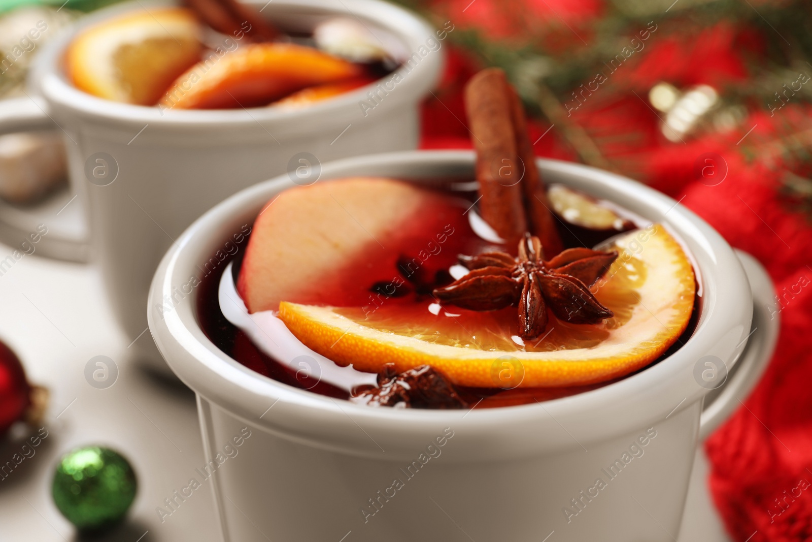 Photo of Cup of tasty mulled wine with spices, closeup