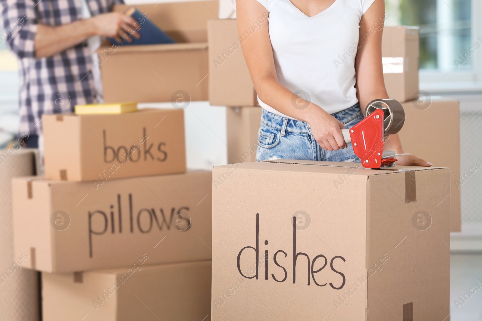 Photo of Woman packing box indoors, closeup. Moving day