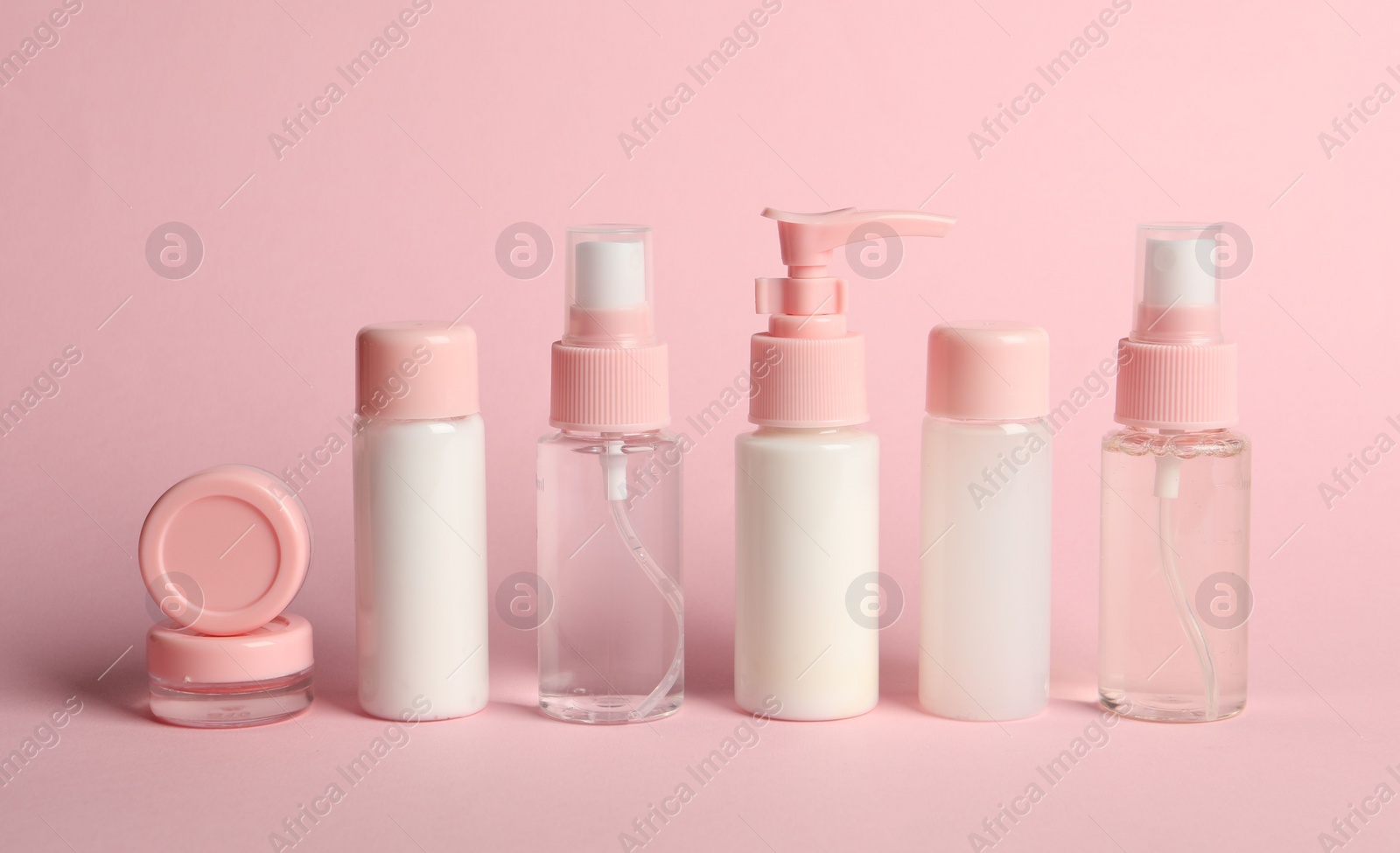 Photo of Cosmetic travel on pink background. Bath accessories