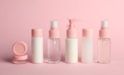 Cosmetic travel on pink background. Bath accessories