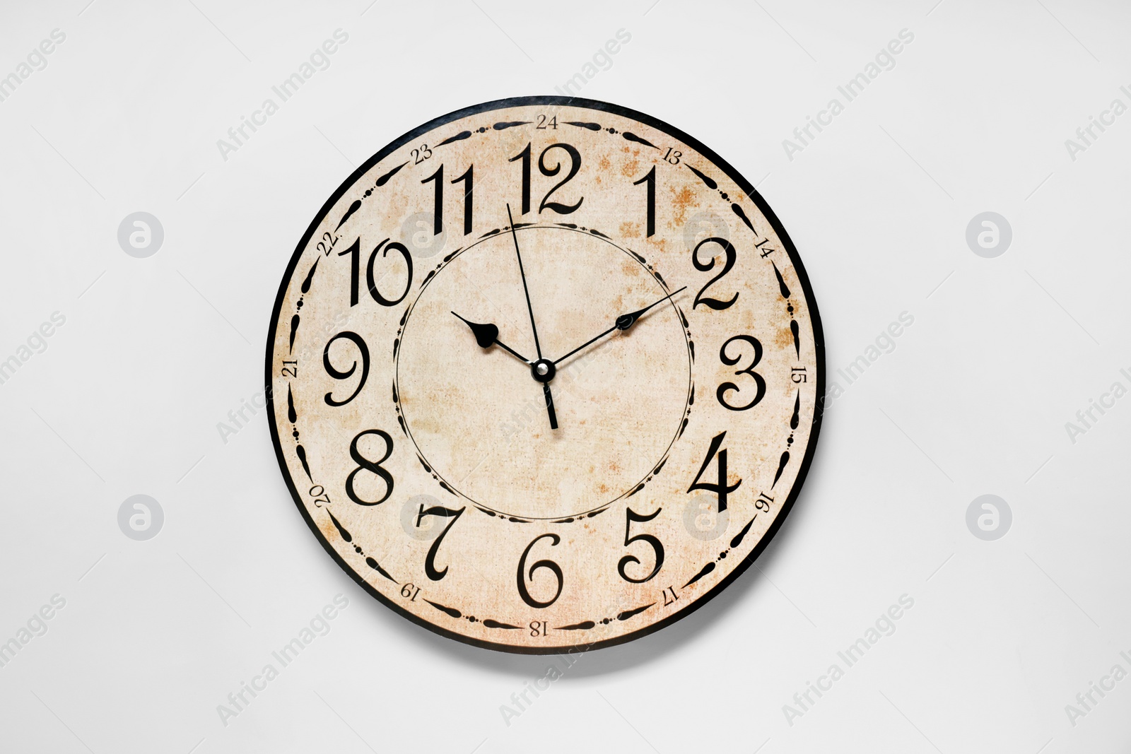 Photo of Stylish round clock on white background, top view. Interior element