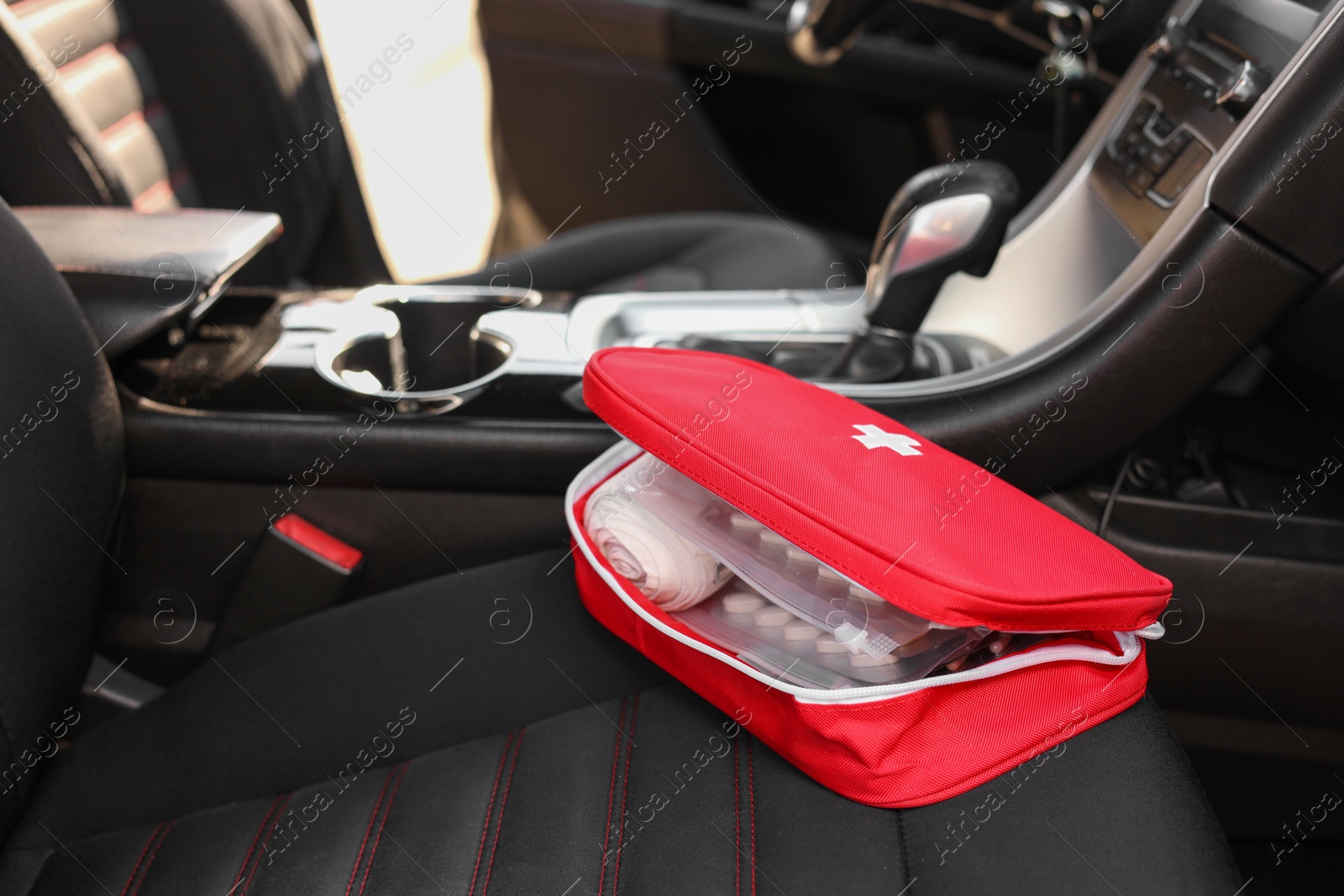 Photo of First aid kit with medicaments inside car