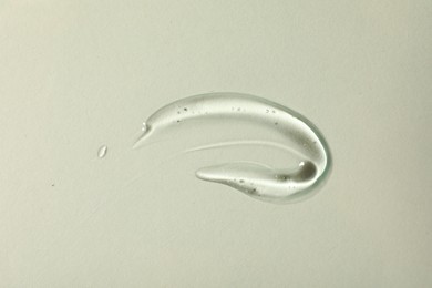 Photo of Sample of cosmetic gel on light background, top view