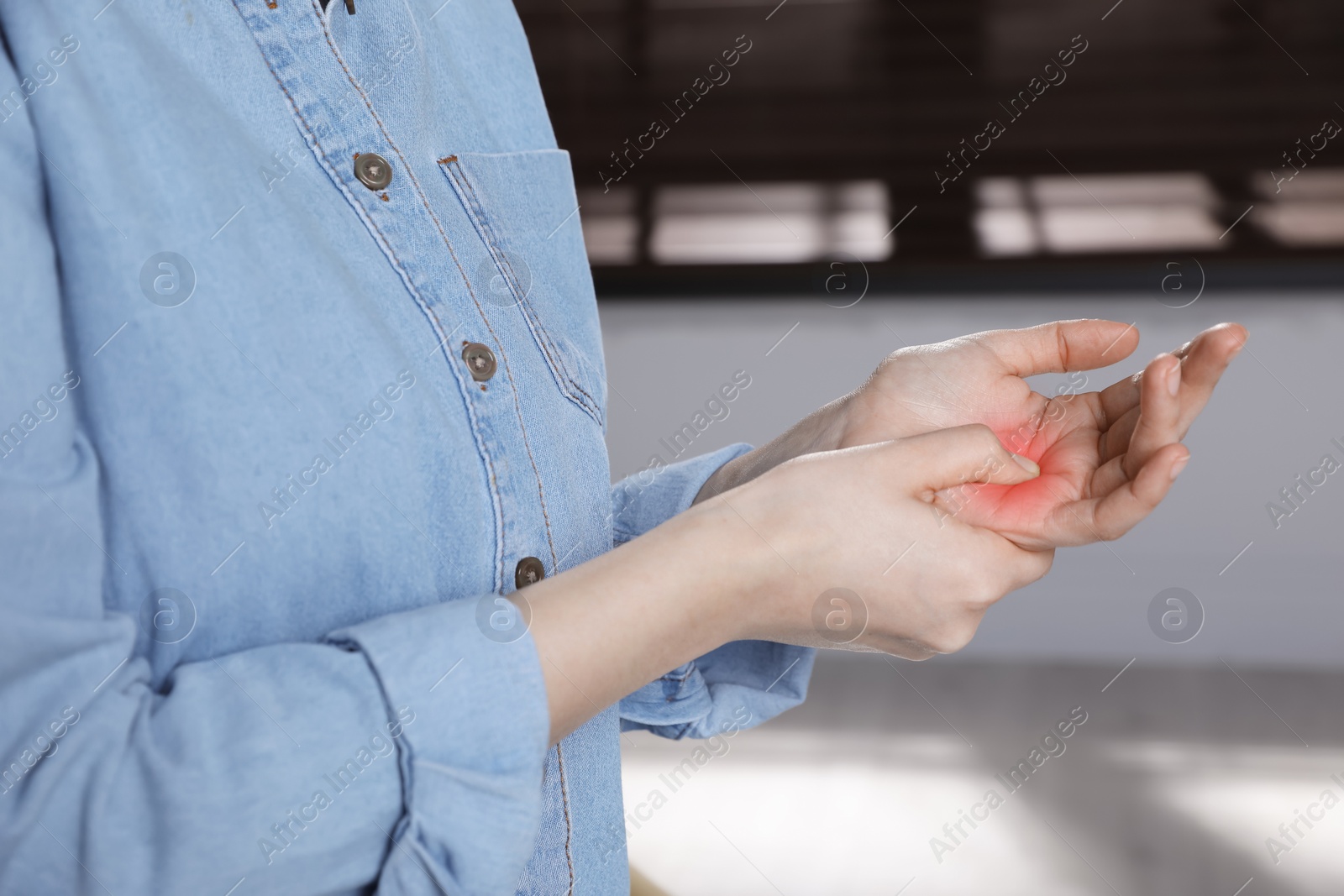 Image of Woman suffering from trigger finger indoors, closeup