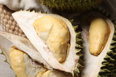 Photo of Fresh ripe durian fruits on table, closeup