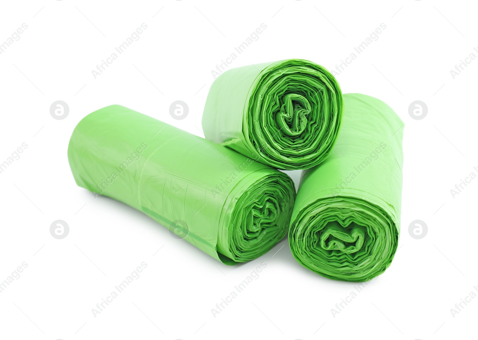 Photo of Rolls of light green garbage bags isolated on white