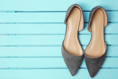 Photo of Pair of female shoes on wooden background