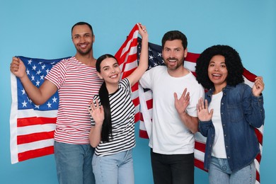 4th of July - Independence Day of USA. Happy friends with American flags on light blue background