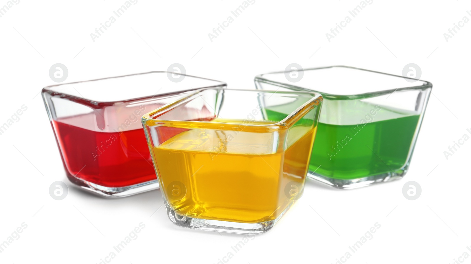 Photo of Tasty jelly desserts in glass bowls on white background