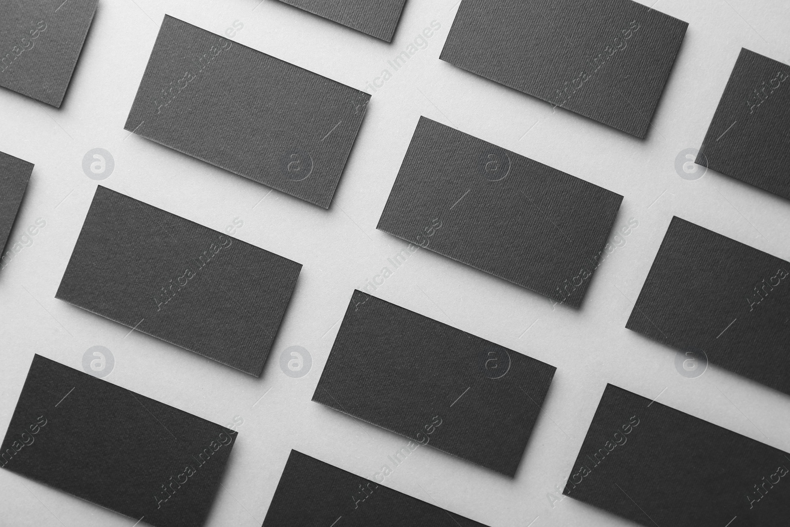 Photo of Blank black business cards on light background, flat lay. Mockup for design