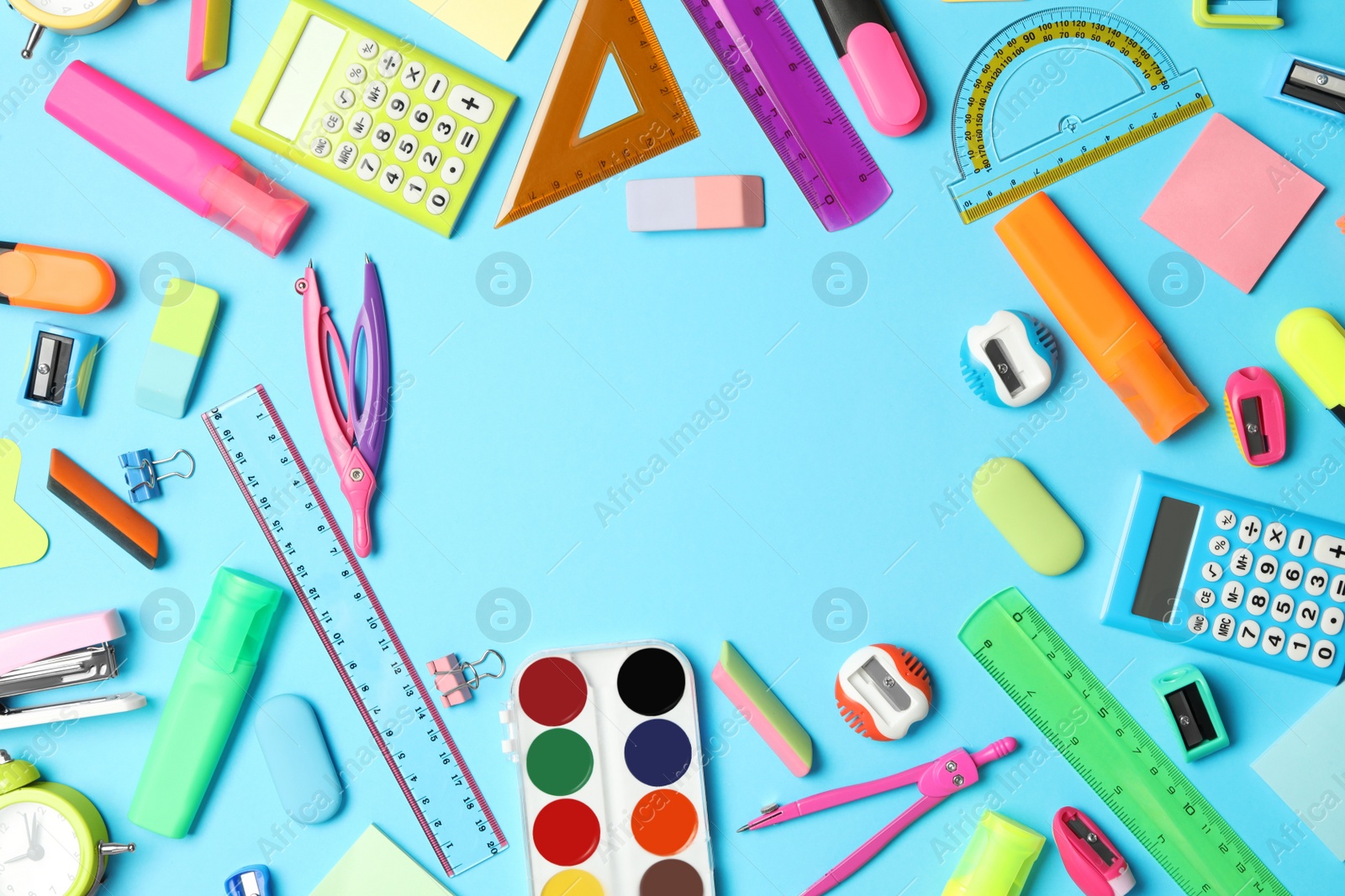 Photo of Frame of different school stationery on light blue background, flat lay and space for text. Back to school