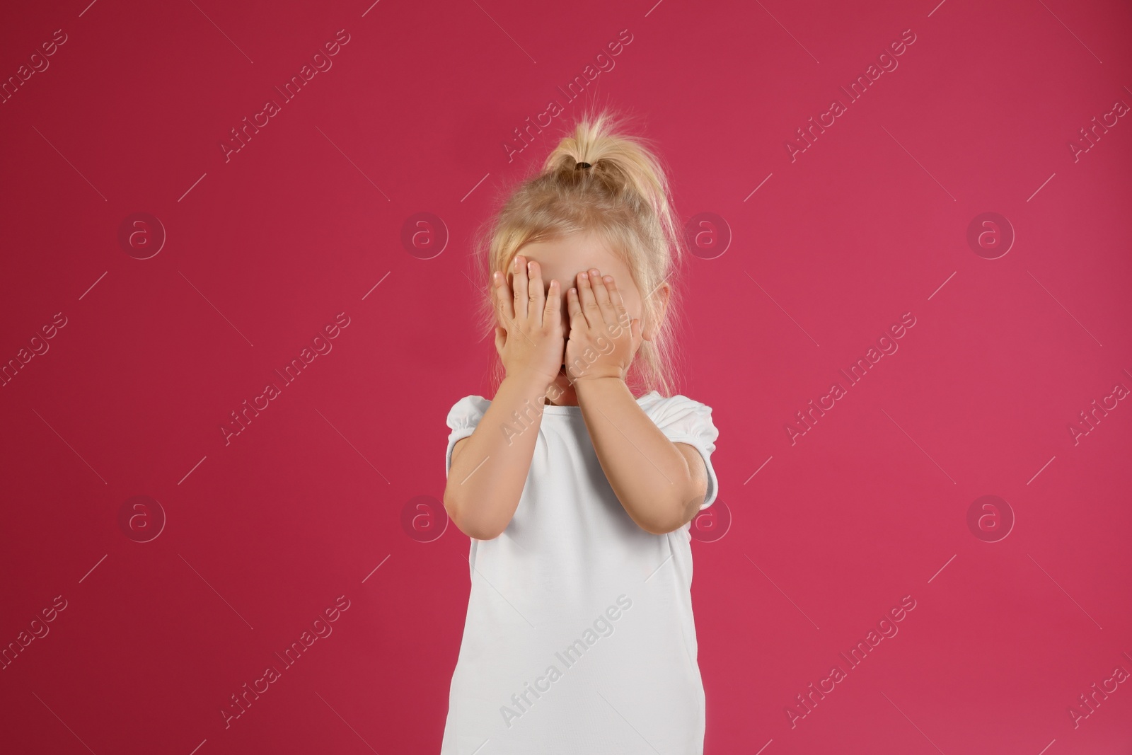 Photo of Cute little girl posing on pink background