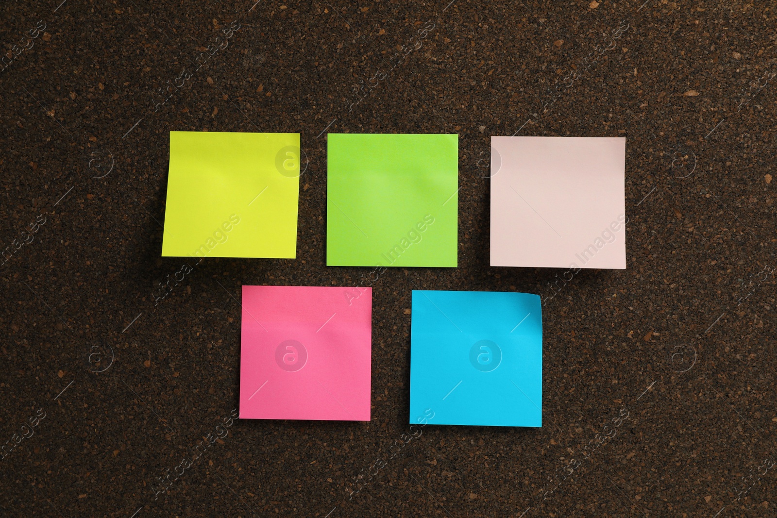 Photo of Empty colorful sticky notes on cork board