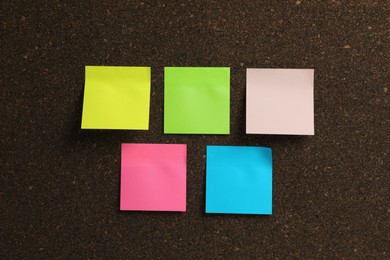 Photo of Empty colorful sticky notes on cork board