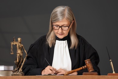 Judge in court dress working with document indoors