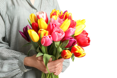 Woman holding beautiful spring tulips on white background, closeup