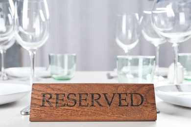 Photo of Table setting with RESERVED sign in restaurant