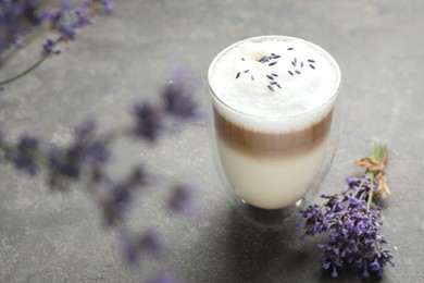 Photo of Delicious latte with lavender on grey table