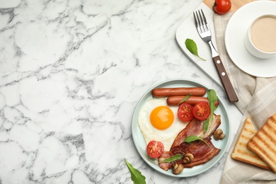 Photo of Tasty breakfast with fried egg served on white marble table, flat lay. Space for text