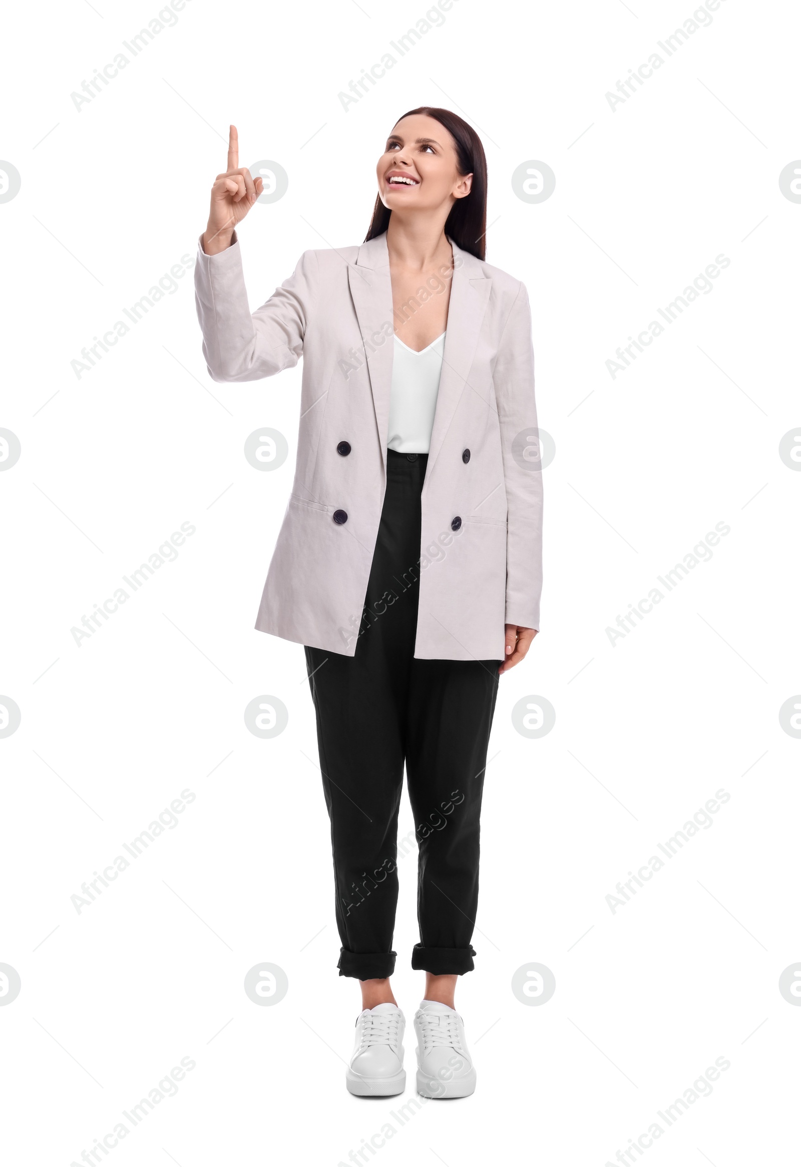 Photo of Beautiful businesswoman in suit pointing at something on white background