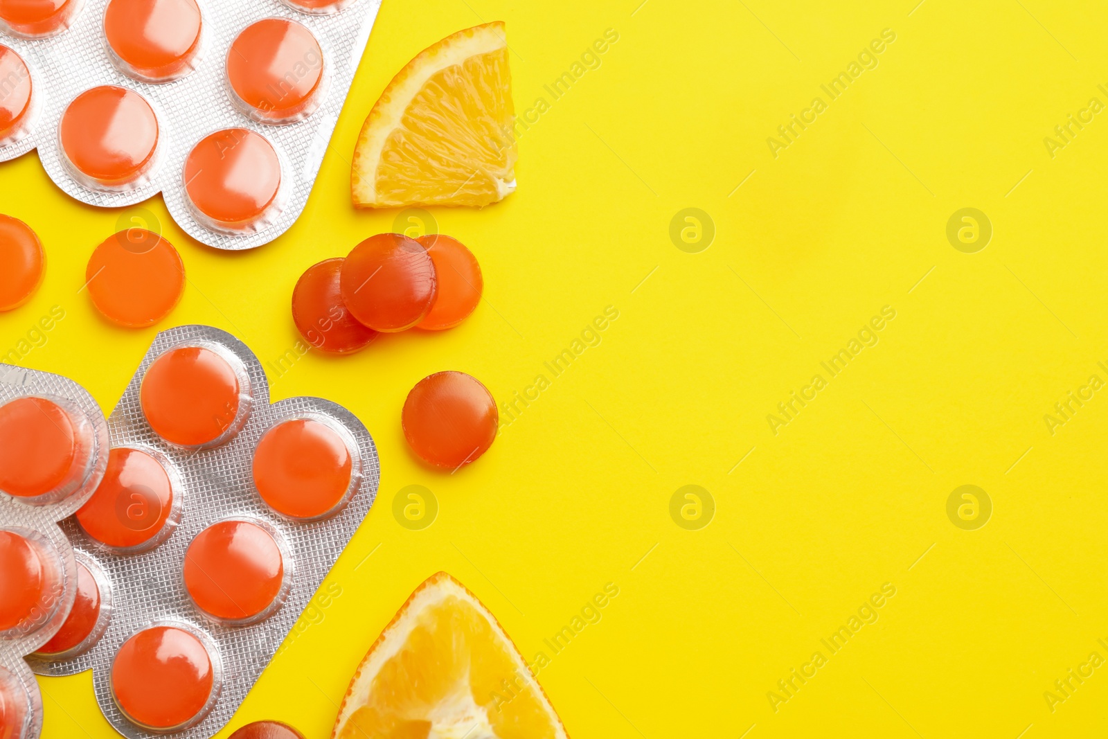 Photo of Many orange cough drops on pink background, flat lay. Space for text