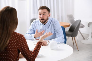 Couple having quarrel in cafe. Relationship problems